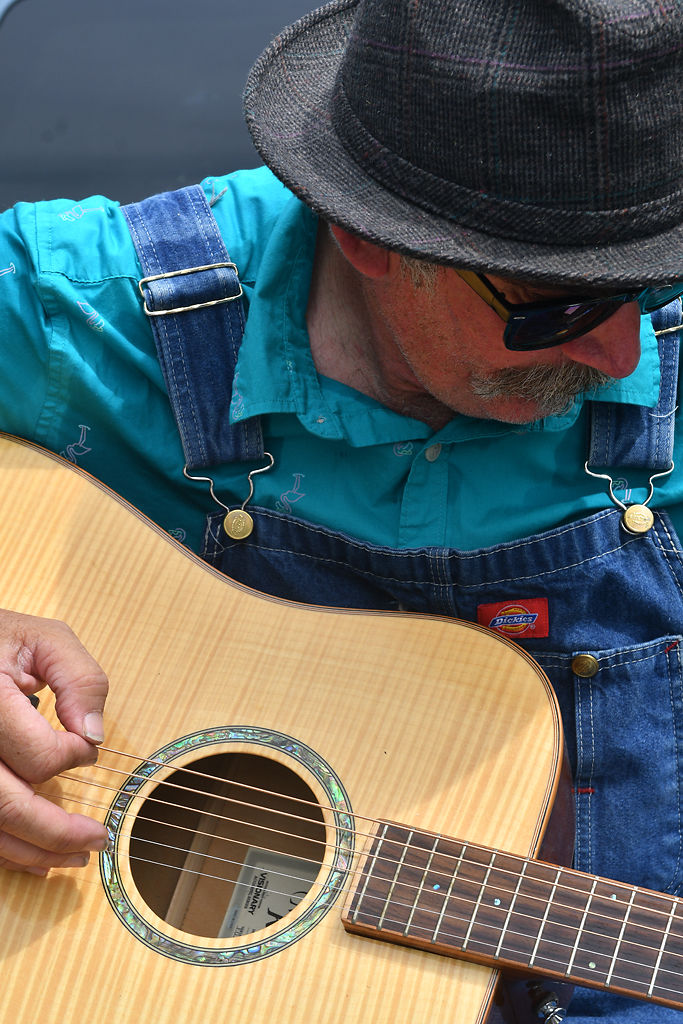 Lyle Burton tunes his guitar before performing